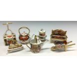 A set of seven Royal Crown derby Imari palette miniature models, comprising watering can, flat iron,