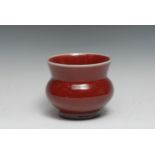 A Chinese monochrome vase, glazed in tones of mottled red, 12.5cm diam