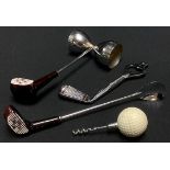 A novelty golf cocktail set, comprising gold ball corkscrew, golf club spoon, shot measure and