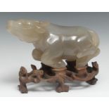 A Chinese hardstone carving, of a water buffalo, pierced and carved hardwood stand, 22.5cm long, c.