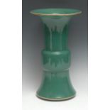 A Chinese monochrome gu-shaped beaker vase, glaze throughout in crackled mint green tones, flared