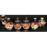 A pair of Royal Crown Derby Imari 2444 pattern ovoid pedestal vases, domed covers with knop finials,