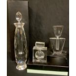 An oversized glass scent bottle, faceted screw stopper, 34cm, boxed; two others smaller, Art Deco