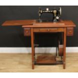 A treadle sewing machine, 79cm high, 85cm wide, 45.5cm deep