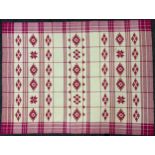 A Traditional Bulgarian Folk Art Table Cloth, woven in red and cream, with stylized motifs within