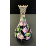 A contemporary Moorcroft bottle vase, tube lined with purple flowerheads, 23cm high, printed and