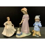 A Lladro figure, of a young girl with a pull-along-toy, printed mark; another, girl with a dog; a