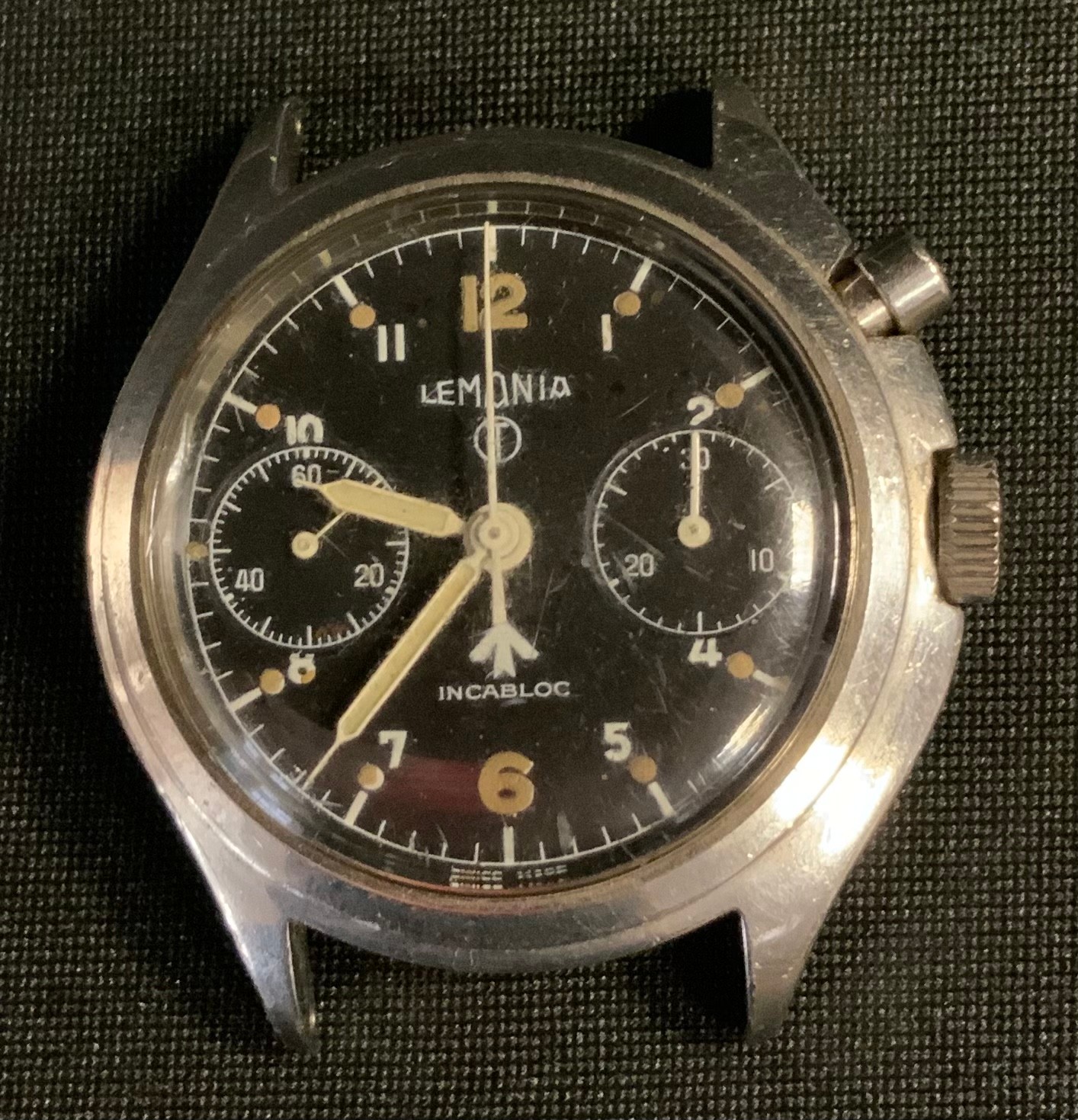 Post war British Army Lemania single button Chronometer watch head, black dial, twin subsidiary