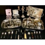 A silver on copper three branch candelabra; a set of six silver plated cake/tea knives and forks,