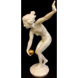 A Hutschenreuther figure, modelled by K Tutter, dancing female nude with golden orb, 25cm, printed