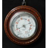 A walnut circular barometer, J.W. Butler, Optician, Scarboro', 21cm diameter overall