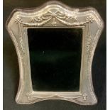 An Elizabeth II silver easel photograph frame, embossed in the Neo-Classical taste, Arthur Price,