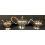 A three piece silver tea service comprising teapot, cream jug and sucriere, Sheffield 1928/1929,