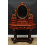 A Victorian mahogany 'Duchess' dressing table, the superstructure with an oval mirror plate above an