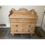 A Victorian pine chest, shaped gallery, above two short one long and two short drawers, turned feet,
