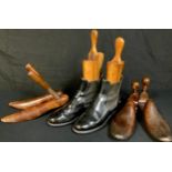 A pair of late 19th/early 20th century leather Chelsea boots, each on wooden shoe tree; other wooden