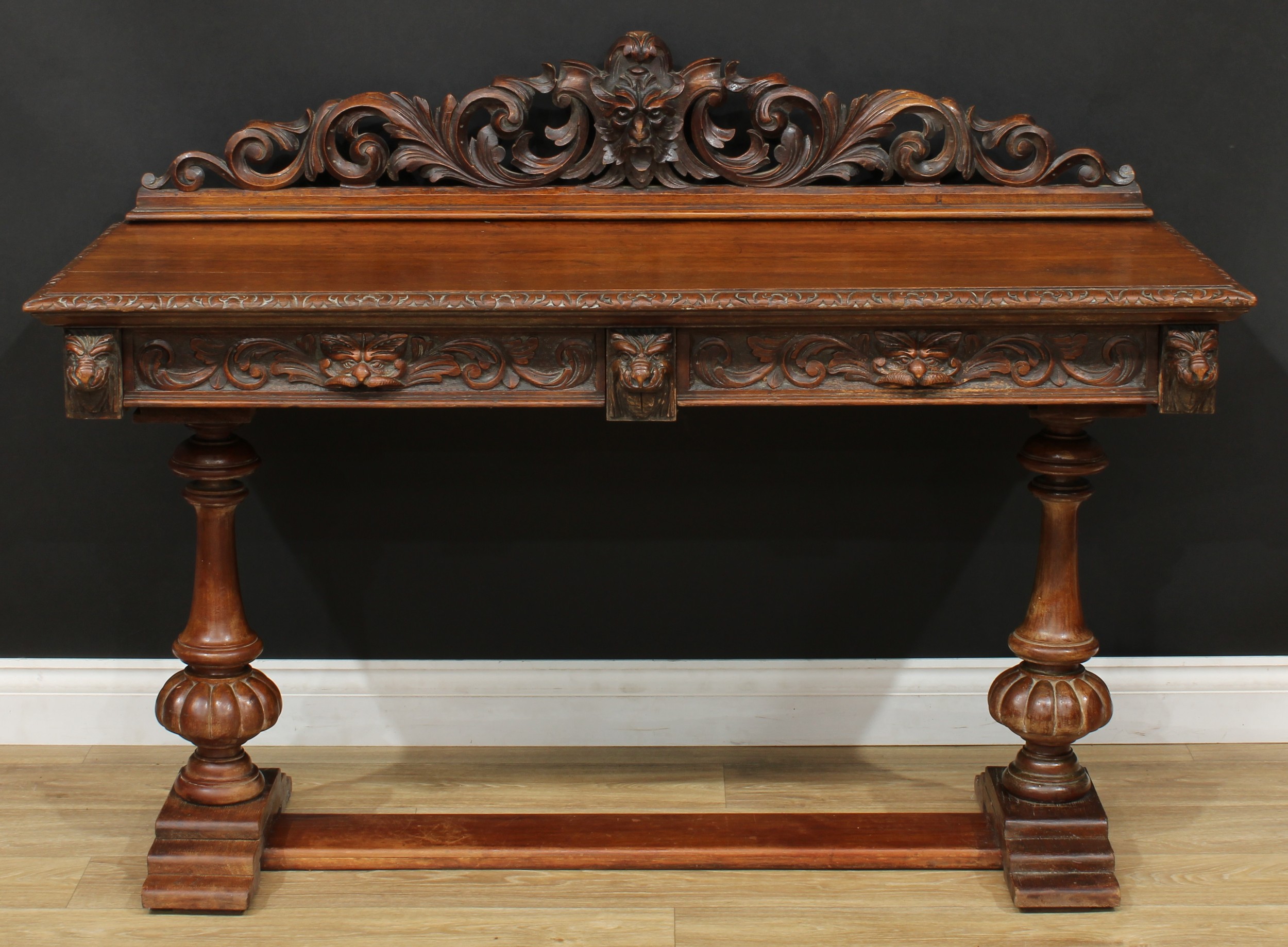 An oak side table or serving table, rectangular top with acanthus carved half-gallery centred by a