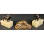 A pair of stone desk weights each mounted with a cold painted model of a spaniel; a bronzed model of