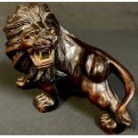 An Oriental wood carving, of a ferocious lion, 20cm long
