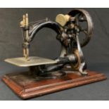 A late 19th century Willcox & Gibbs hand cranked sewing machine, mounted on mahogany base