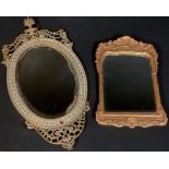 A brass oval wall mirror, pierced openwork scroll supports, 56cm high; a moulded plaster rounded