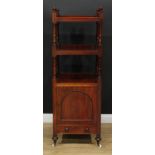 An early Victorian mahogany buffet whatnot, open plateaux above a panel door and a long drawer,