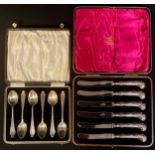 A set of silver teaspoons, Birmingham 1928, cased, 96g; a set of silver hafted butter knives,