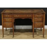 An early 20th century mahogany desk, slightly oversailing top with inset writing surface above an
