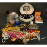 A 1950s/60 musical ballerina manicure set; scent bottles; an enamel hinged bangle; bead necklaces;