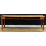 A 19th century vernacular pitch pine serving table, slightly oversailing rectangular top above above