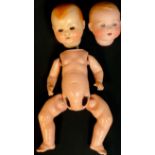 An Armand Marseille bisque baby doll head, 351/6.K; a composite baby doll head and body parts