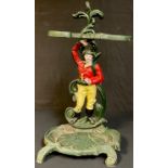 A cast iron figural stick or umbrella stand, painted in shades of green, yellow and red, 58cm
