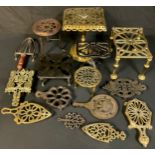 A collection of Victorian and later brass and iron trivets