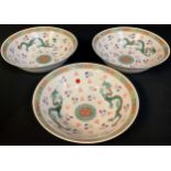 Oriental - three Chinese porcelain bowls, decorated with dragons chasing pearl of wisdom, 23cm