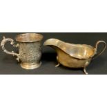 A Victorian silver christening mug, embossed and chased, the central cartouche inscribed, Ruth