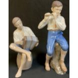 A pair of Bing & Grondahl figures, musicians with accordion and flute, numbers 1897 and 1661, the