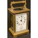 A late 19th/early 20th century French brass carriage timepiece, Roman numerals on white enamel