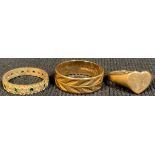 A 9ct gold ring, a 9ct gold heart shaped ring, a 9ct gold eternity ring set with stones, 8.6g (3)