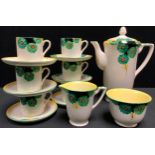 An Art Deco Crown Devon coffee set for six, painted with green flowers on a cream ground, pattern