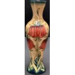 A contemporary Moorcroft slender inverted baluster vase, tube lined with tall flowers in shades of
