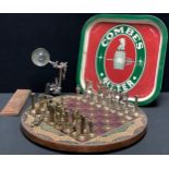 An advertising breweriana Combes Bitter bar tray; a cribbage board; a chess set of board; a desk top