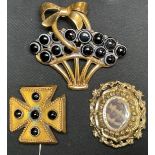 A Victorian gold coloured metal mourning brooch, the centre with woven hair; a Victorian cross