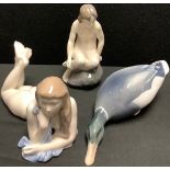 A Royal Copenhagen figure, maid on a rock, number 4027, 14cm; others, resting female nude, number