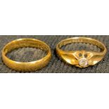 A 22ct gold wedding band, ring size K, 2.9g; an 18ct gold diamond solitaire ring, size L, 2.1g (2)