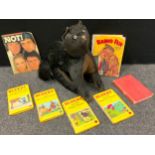 Toys - An early 20th century black cat stuffed toy, standing, ears erect, back arched, curled