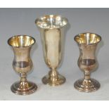 A pair of silver thistle shaped cups, silver gilt, 8cm high, London 1975; a silver flared