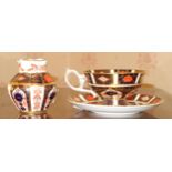 A Royal Crown Derby 1128 pattern pedestal teacup and saucer, printed marks; a similar lobed ovoid