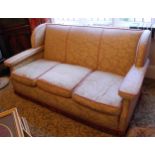 An Art Deco three seat sofa, arched wings, 185cm wide