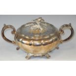 A silver lobed ovoid two handled sugar bowl and cover, flower finial, splay feet, 10cm high, E H P