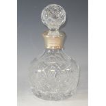 A silver mounted cut glass mallet shaped decanter with globular stopper, fan and hobnail cut, star